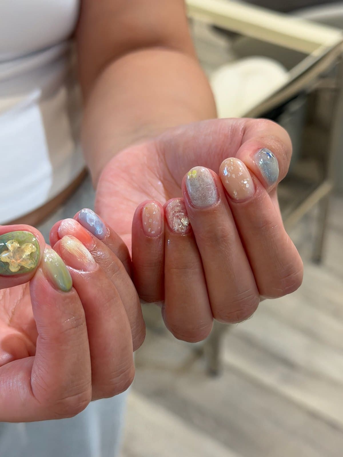 Short gel nails in milky pastels with a pearl and gold accent nail at Joy Nail Studio Vancouver