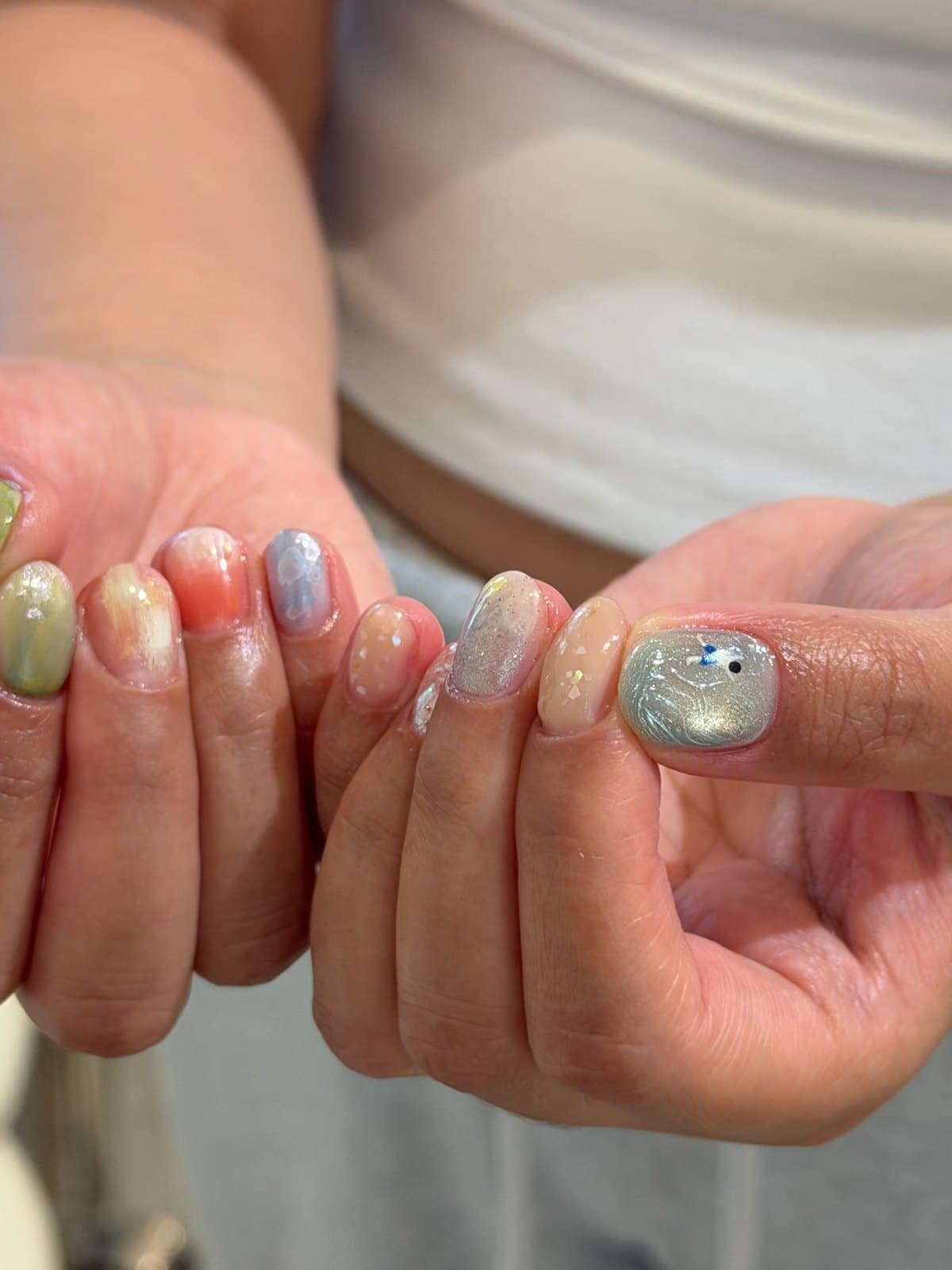 Soft pastel gel nails in blue, cream and pink with marble detail at Joy Nail Studio Vancouver