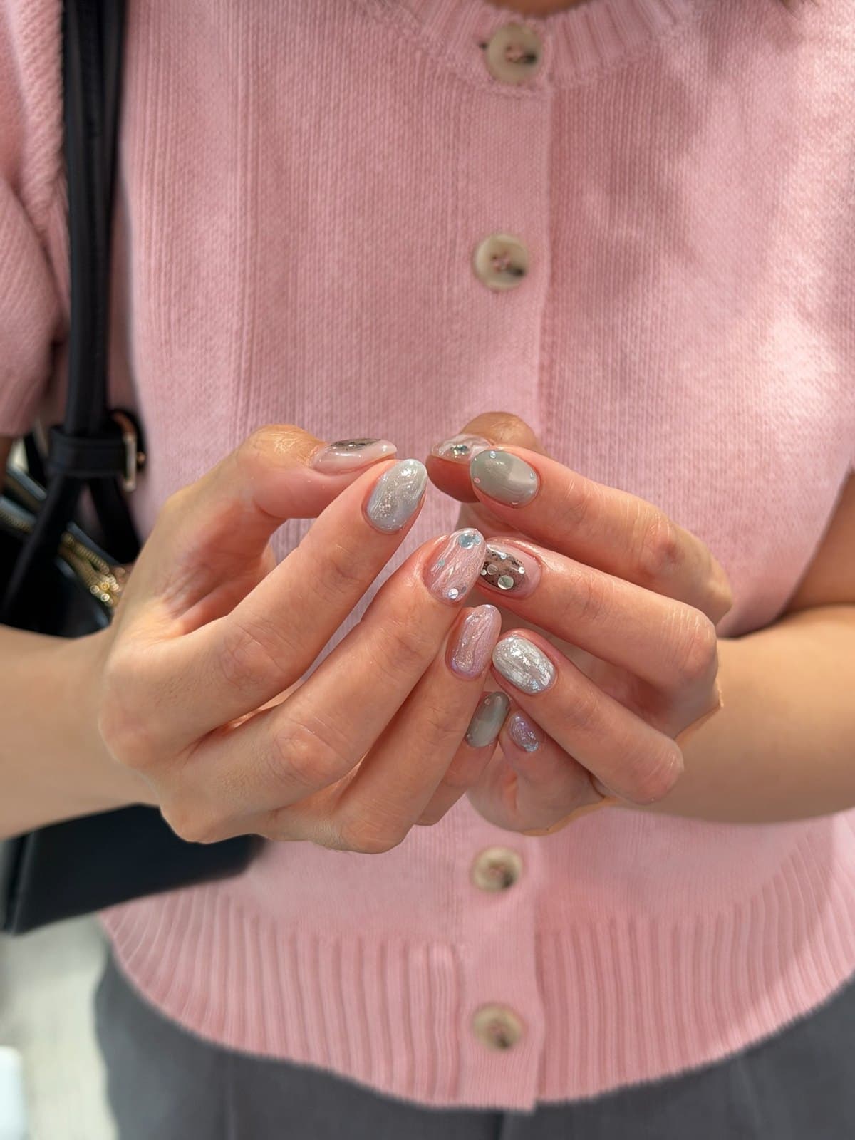 Milky grey gel nails with silver flakes and fine marble detail at Joy Nail Studio Vancouver