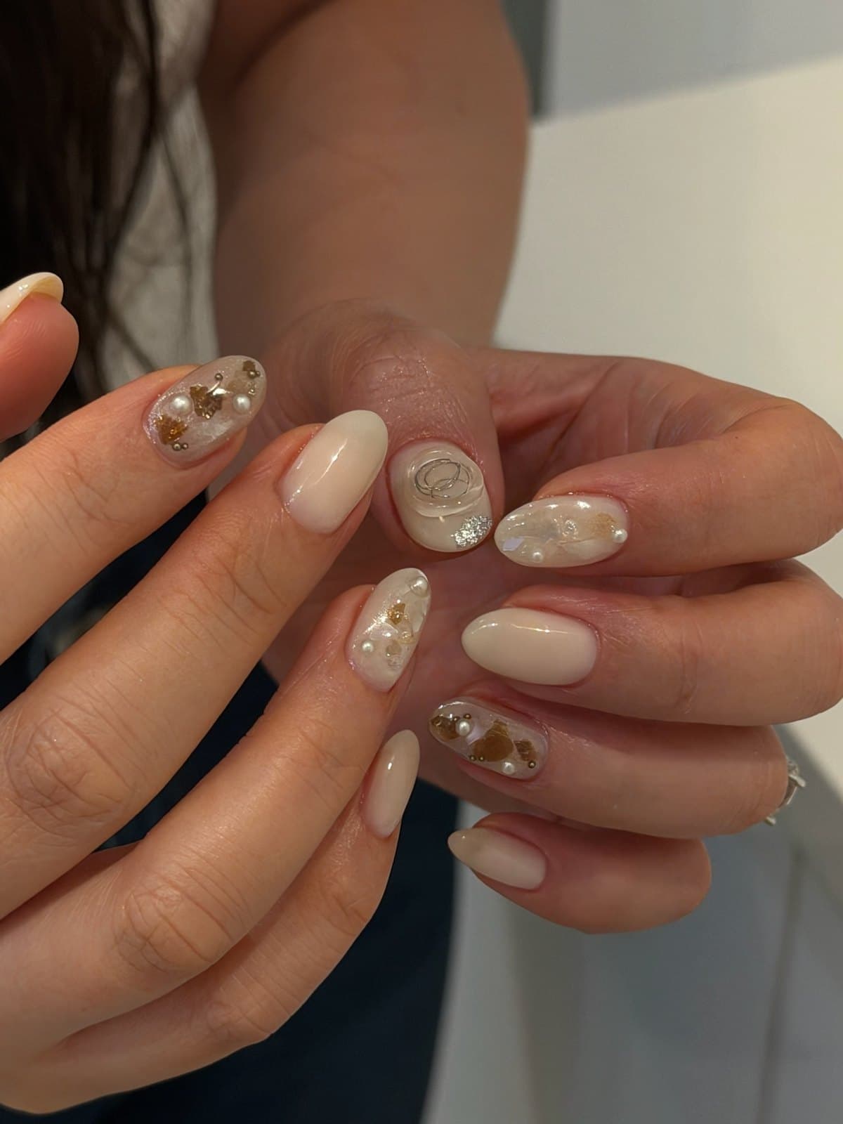 Nude and cream gel nails with gold foil and marble accents at Joy Nail Studio Vancouver