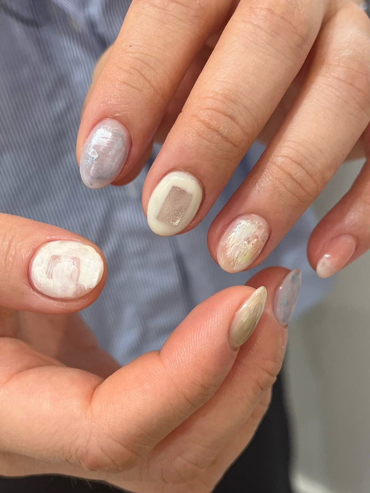 Short gel nails in olive, cream and grey with a marbled finish at Joy Nail Studio Vancouver