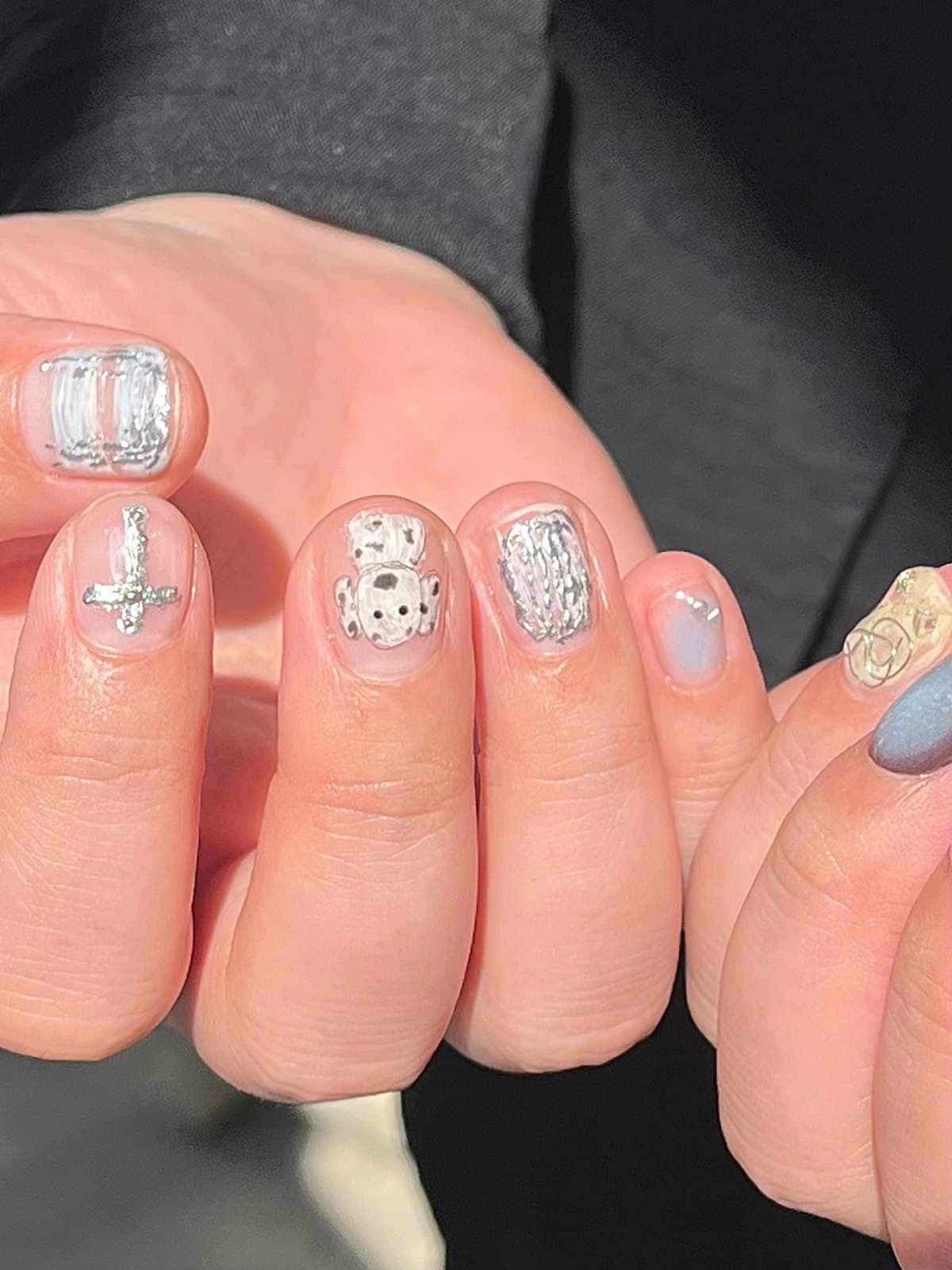 Short gel nails with silver relief art and soft nude bases at Joy Nail Studio Vancouver