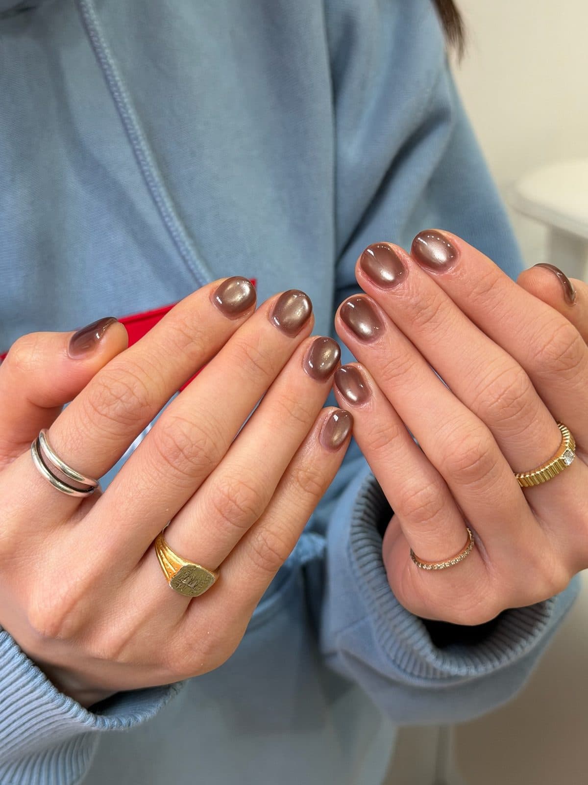 Short round gel nails in a warm brown mirror chrome at Joy Nail Studio Vancouver