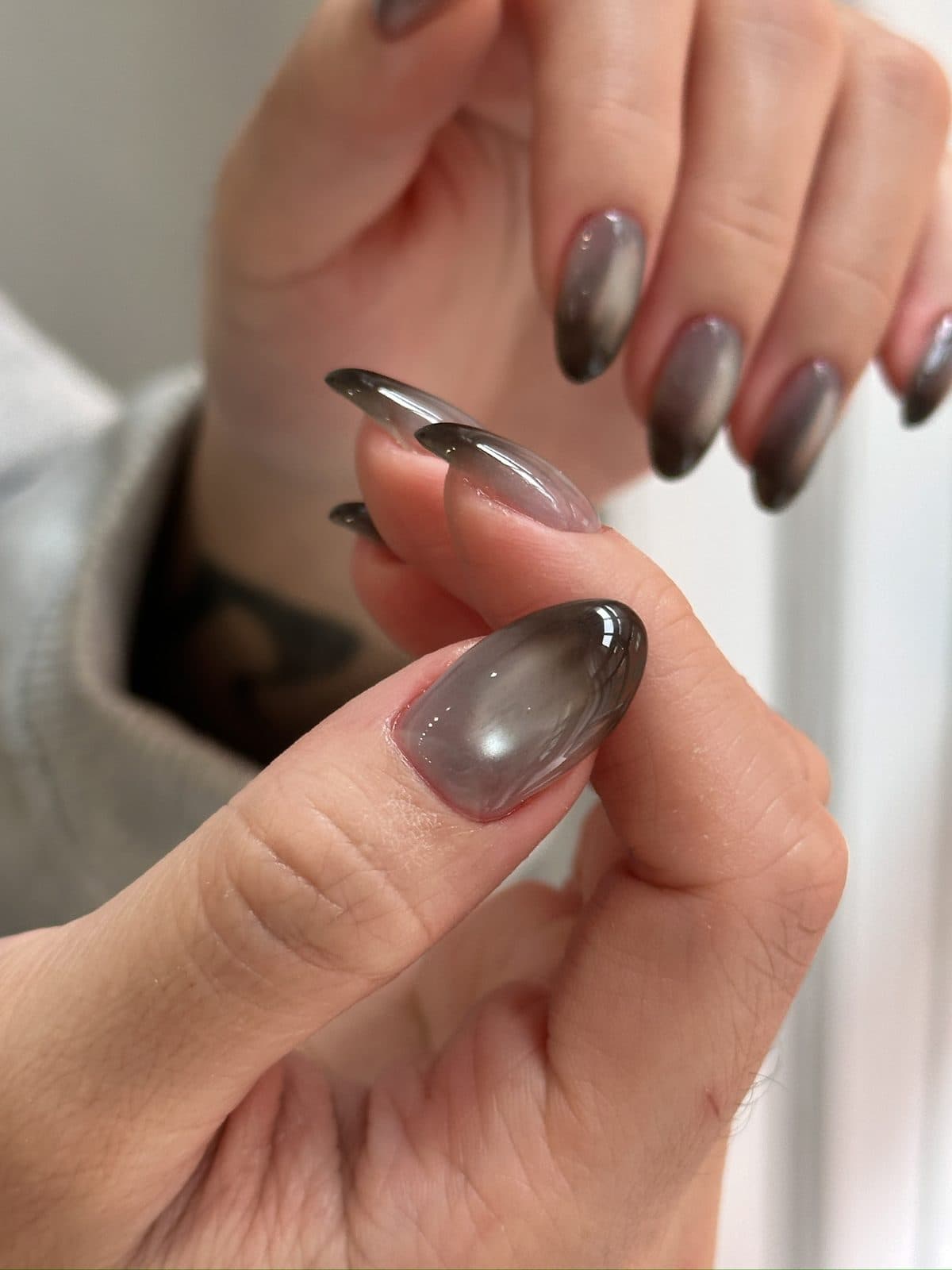 Close-up of the shifting shimmer in a brown cat-eye gel nail at Joy Nail Studio Vancouver