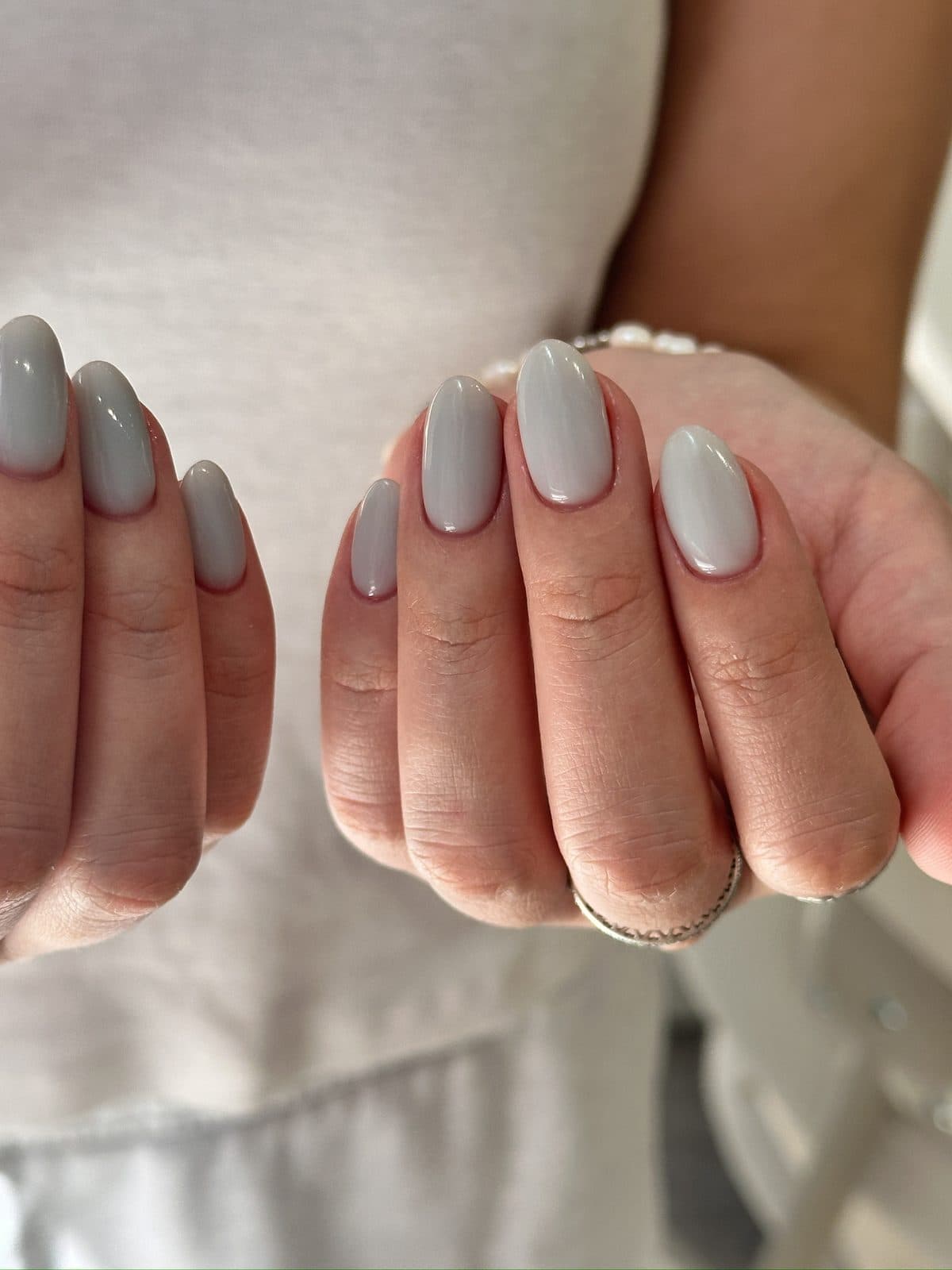 Almond gel nails in a glossy greige, shaped clean to the cuticle at Joy Nail Studio Vancouver