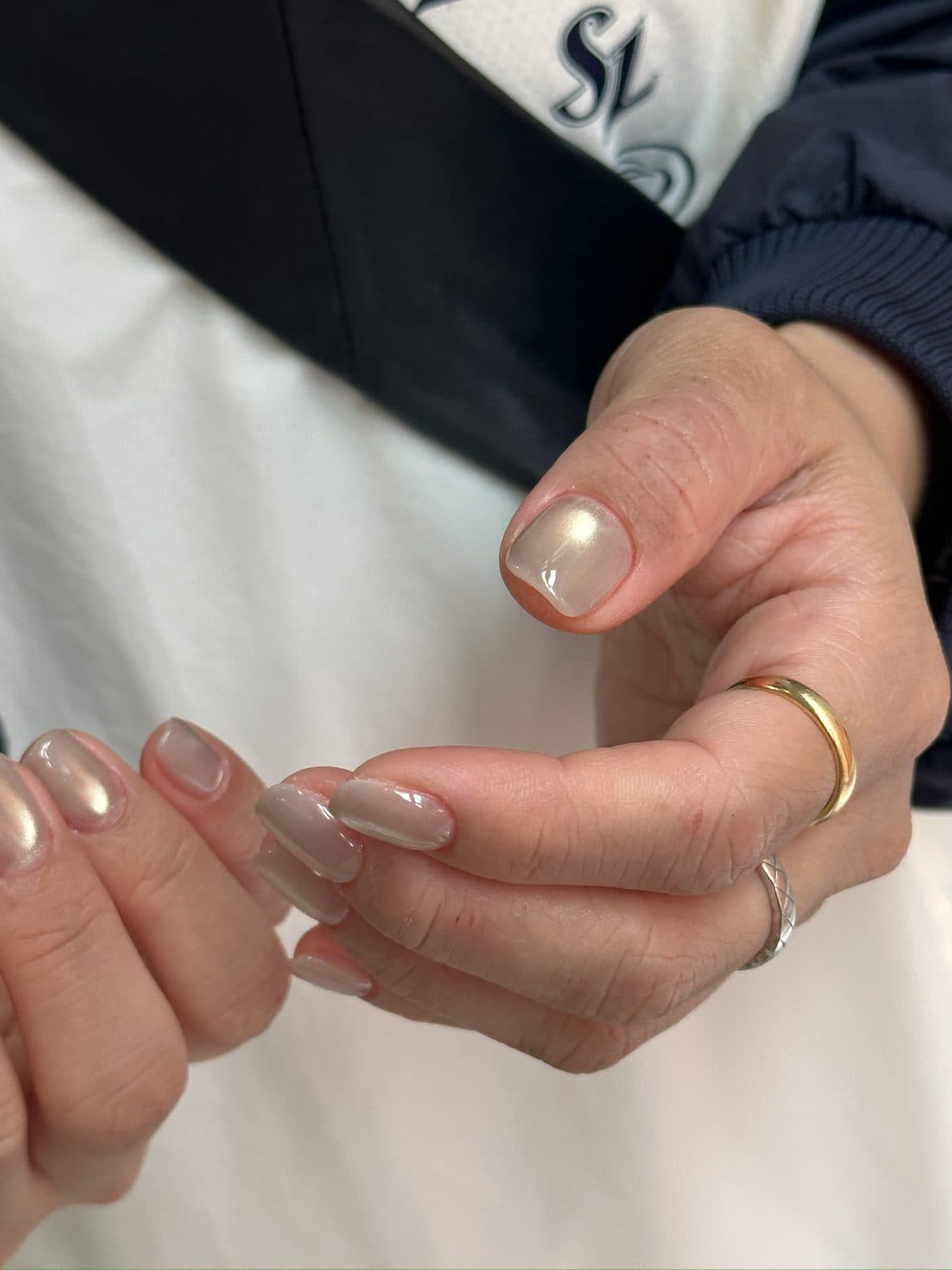 Close-up of the warm shift in a cream milk chrome gel nail at Joy Nail Studio Vancouver