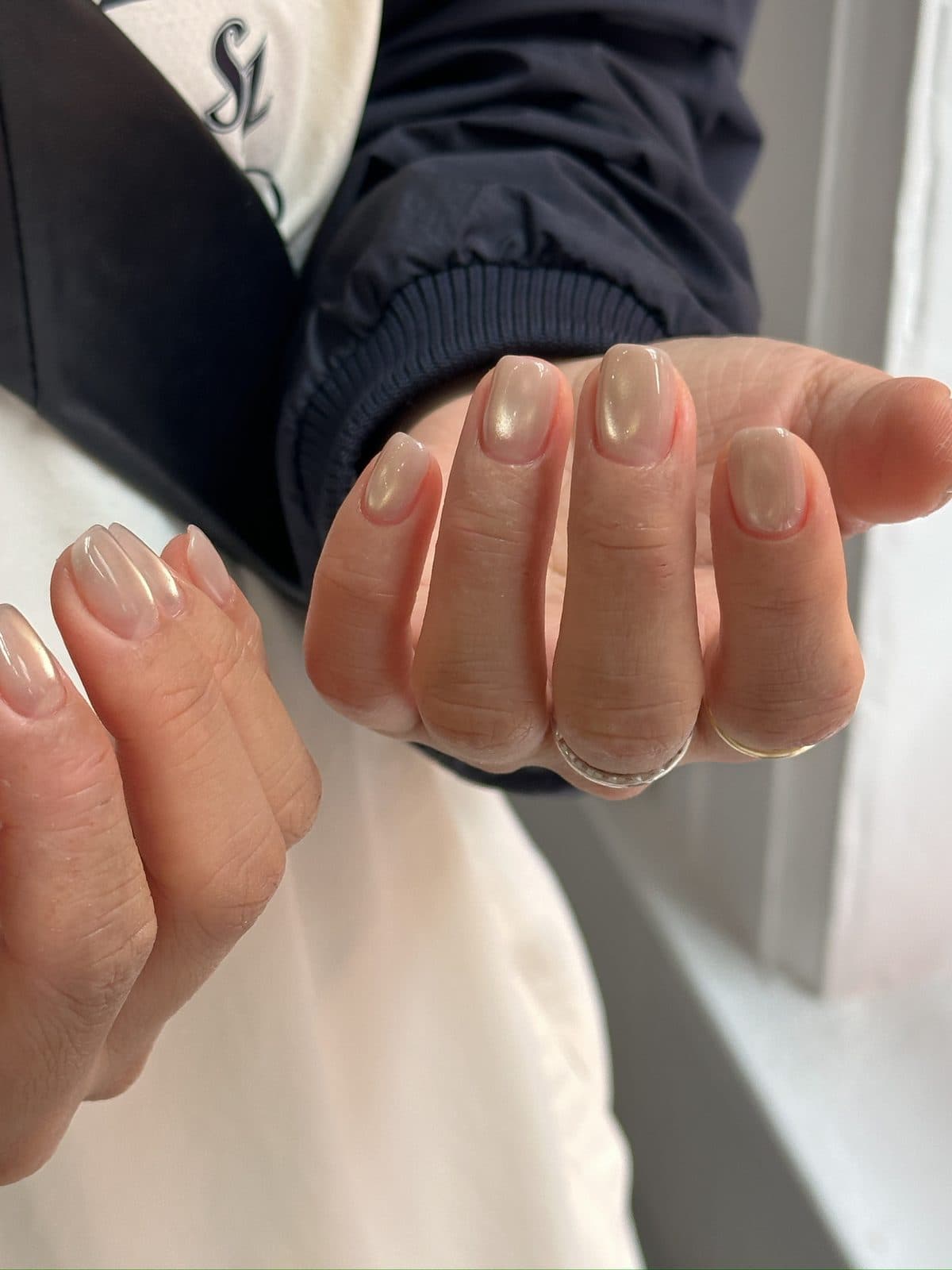Short round gel nails in a soft cream milk chrome at Joy Nail Studio Vancouver