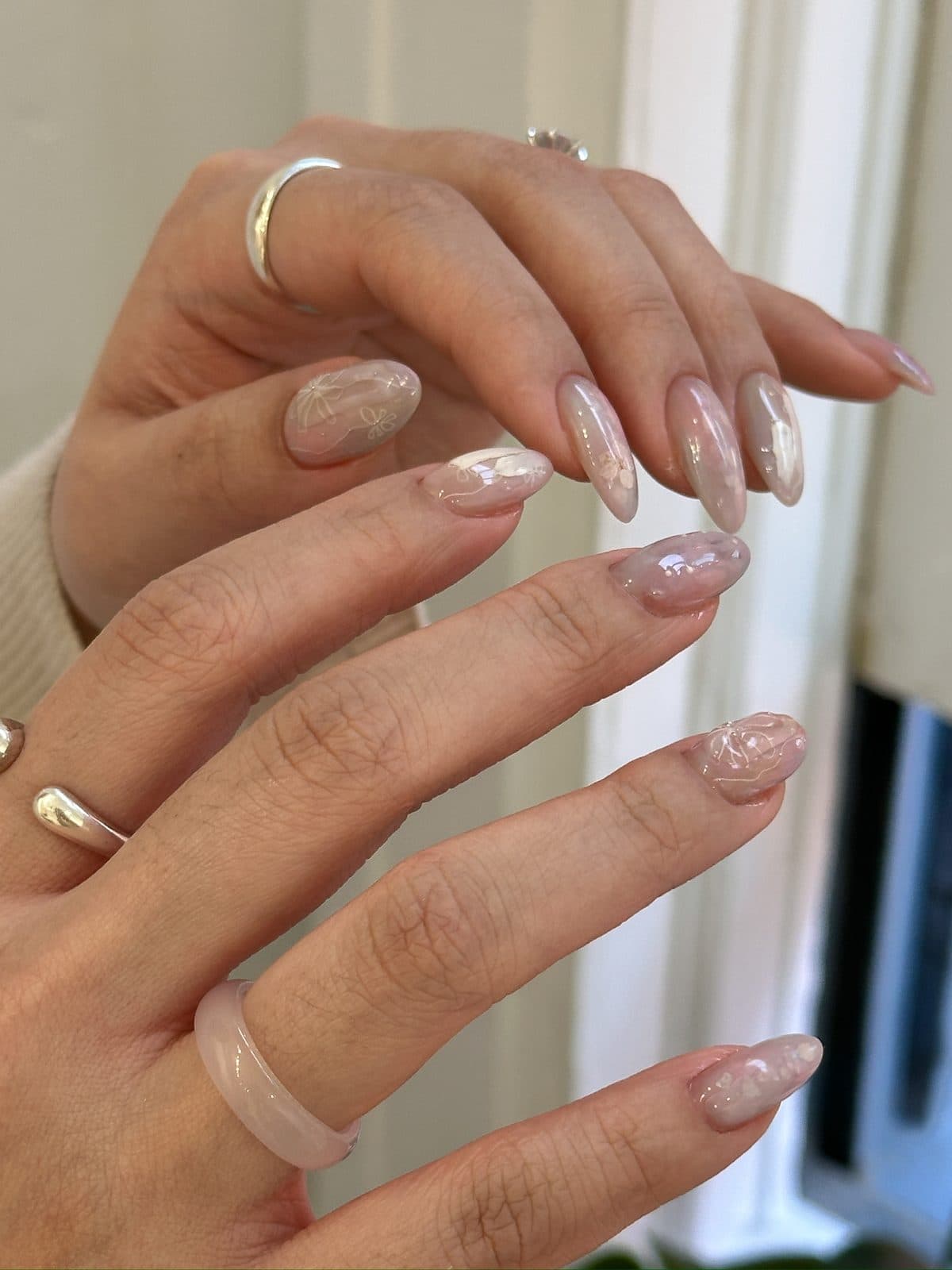 Almond gel nails in milky nude with soft marbling at Joy Nail Studio Vancouver