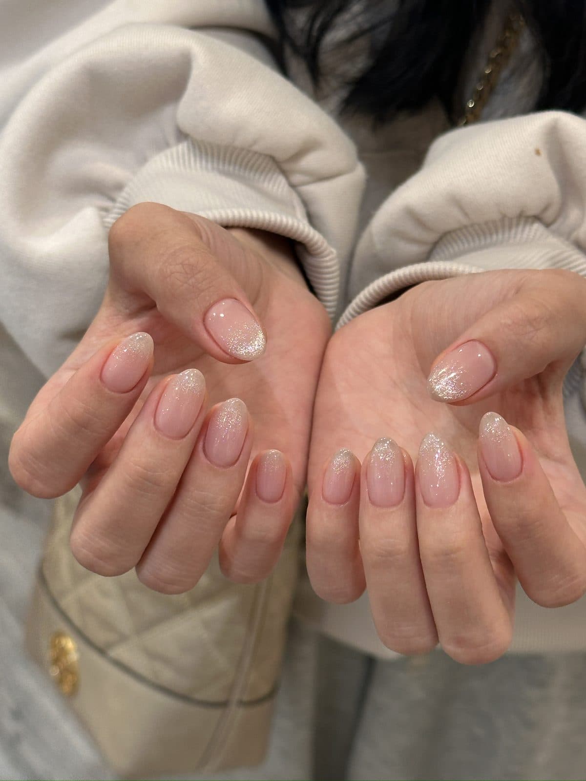 Gel nails in a nude-to-pink glitter ombre on both hands at Joy Nail Studio Vancouver