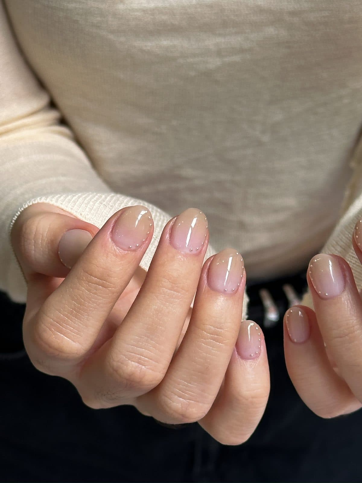 Sheer nude gel nails with a fine French line and micro dots at Joy Nail Studio Vancouver