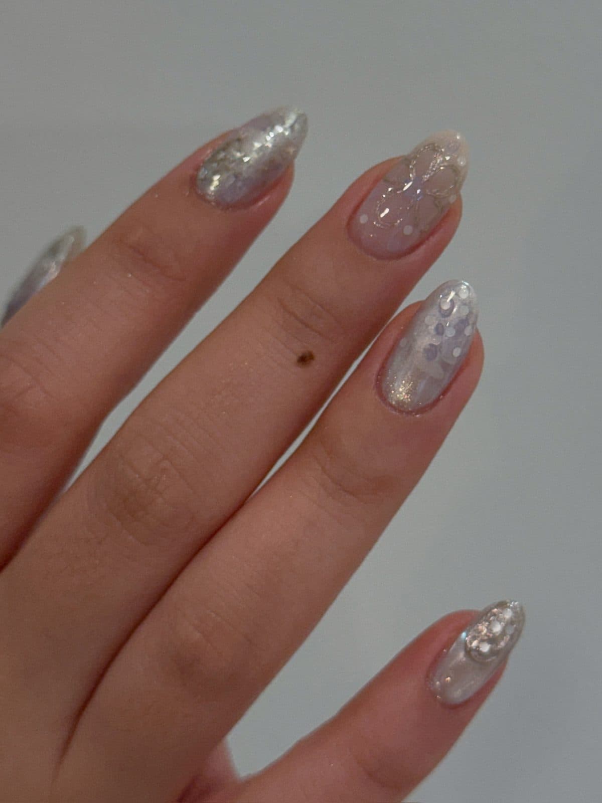 Almond gel nails in silver glitter and grey marble at Joy Nail Studio Vancouver