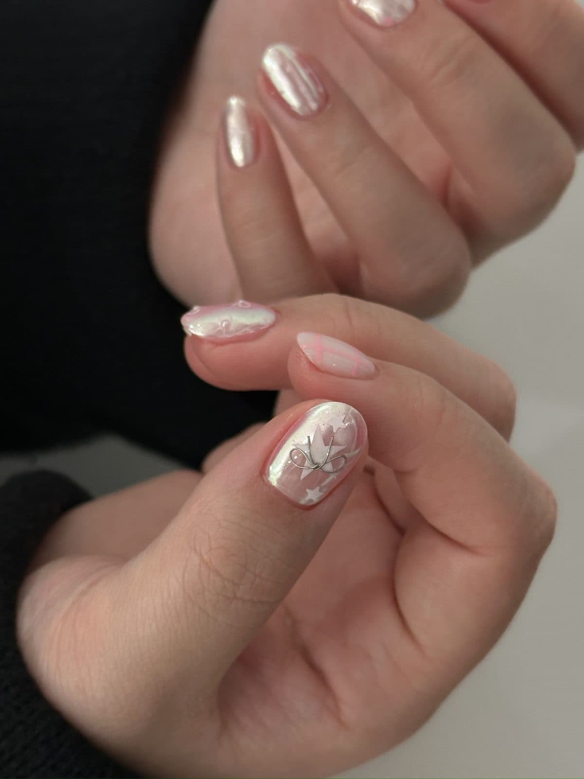 Short gel nails in cream with silver line flower art at Joy Nail Studio Vancouver