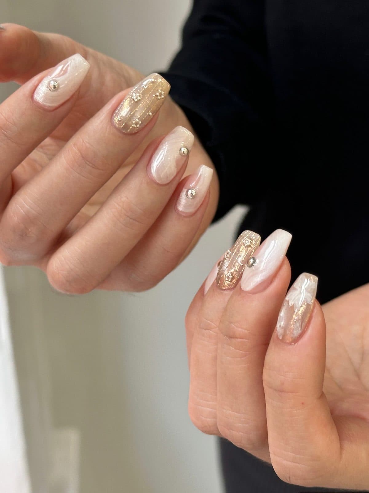Long coffin gel extensions in white marble with gold foil at Joy Nail Studio Vancouver