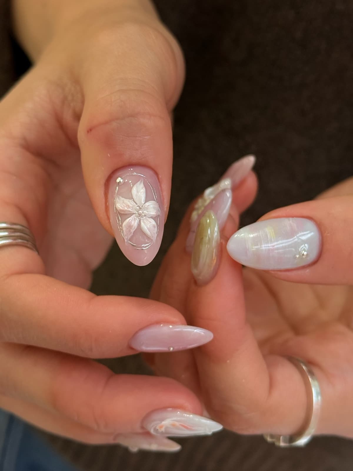 Sheer pink almond Korean gel nails with pearl shimmer and floral art by Joy Nail Studio Vancouver