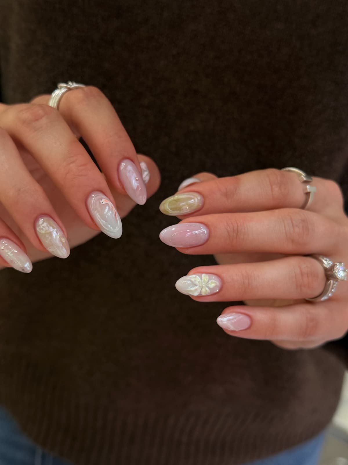 Milky pink glazed Korean gel almond nails with a white 3D flower accent by Joy Nail Studio Vancouver